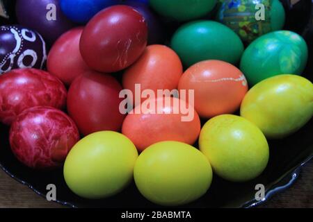 Easter background. Art decorated eggs on black dplate. Patterns of art and colors on eggs. Stock Photo