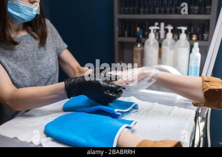 Spa Salon. Manicure. Paraffin Hand Bath. process paraffin treatment. Bowl, additive. Wax bathtub Care. Nail care. Nail artist doing manicure Stock Photo