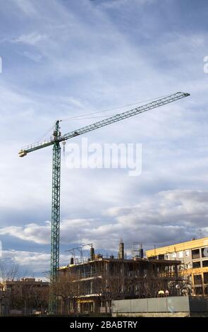 Image of a crane on a construction site that is constructing a building in a city, copy space Stock Photo