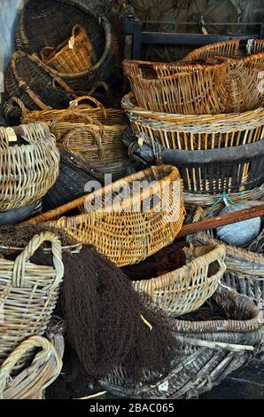 old twig willow fishing baskets, creels and fishing net. Stock Photo