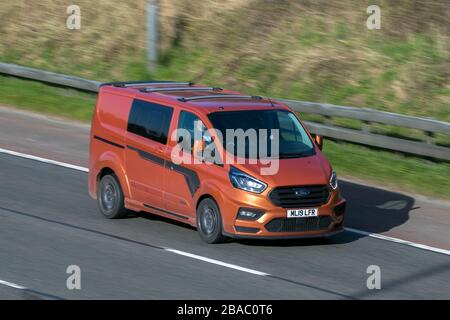 ML19LFR 2019 Ford Transit Custom 320 Limited A Orange LCV Diesel driving on the M6 motorway near Preston in Lancashire, UK Stock Photo