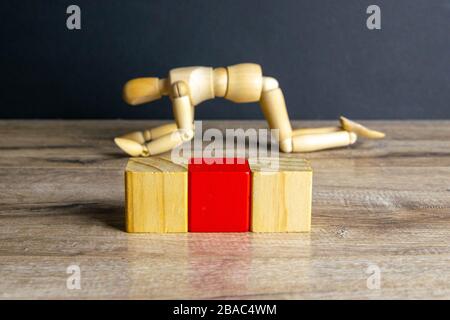 The concept of sadness, satomy, man became disillusioned with himself - wooden mannequin with surreal wood cube isolated on white background Stock Photo