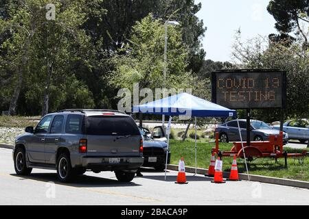 Pacoima, United States. 26th Mar, 2020. PACOIMA, LOS ANGELES, CALIFORNIA, USA - MARCH 26: A car queues to the entrance of a coronavirus COVID-19 testing center at Hansen Dam Park on March 26, 2020 in Pacoima, Los Angeles, California, United States. California, the most populous US state, has been one of the worst-hit during the pandemic. (Photo by Xavier Collin/Image Press Agency) Credit: Image Press Agency/Alamy Live News Stock Photo