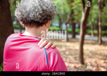 senior  woman having shoulder  pain Stock Photo