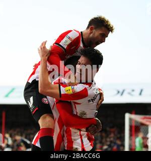 Brentford's Emiliano Marcondes Camargo Hansen (left) and Brentford's Christian Norgaard (right) celebrate after Brentford's Ollie Watkins (not pictured) scored his side’s third goal Stock Photo