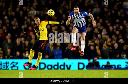 Watford's Gerard Deulofeu (left) and Brighton and Hove Albion's Lewis Dunk battle for the ball in the air Stock Photo