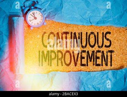 Handwriting text writing Continuous Improvement. Conceptual photo ongoing effort to improve products or processes Stock Photo