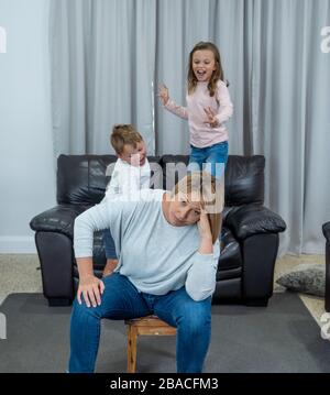 Stressed out parents struggling with having the children at home during Coronavirus self-isolation. Mother and father trying to cope with anxious kids Stock Photo