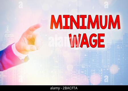 Writing note showing Minimum Wage. Business concept for the lowest wage permitted by law or by a special agreement Stock Photo