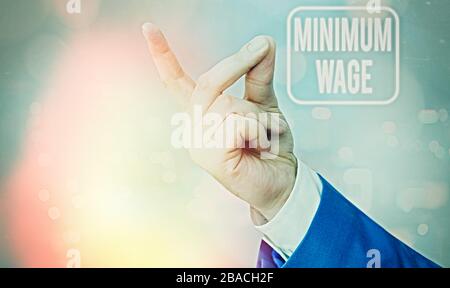Writing note showing Minimum Wage. Business concept for the lowest wage permitted by law or by a special agreement Stock Photo