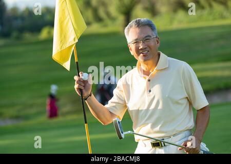 Happiness of the elderly with golf balls and clubs Stock Photo
