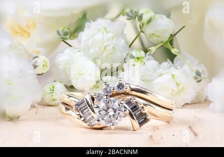 Diamond wedding ring splay with white baby's breath flowers Stock Photo