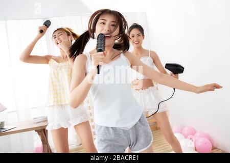 Best friend in the bedroom to play pretend to sing Stock Photo