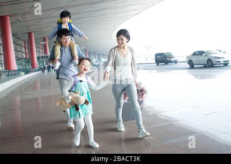 A happy family with luggage at the airport Stock Photo