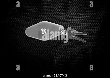 Keys with name sign on black background Stock Photo
