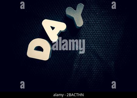 Day spelled on black with block letters Stock Photo