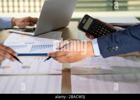 calculator finance accounting achievement to balance man assistant accounting analyzing financial document data charts and graphs Stock Photo