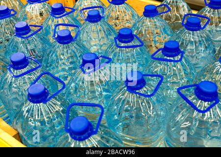 Stock of drinking bottled water. Drinking water bottles in a store. Party plastic bottles of water Stock Photo
