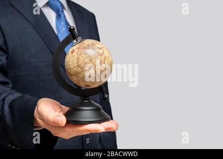 A businessman holding a globe. With copy space. Stock Photo