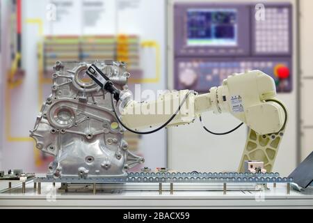 Industry robotic 3D scan work scanning auto part via conveyor belt on smart factory on blurred control panel background, industry 4.0 Stock Photo