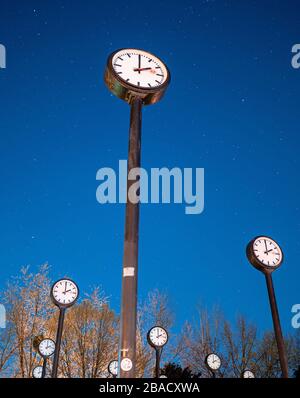 Duesseldorf, Germany. 26th Mar, 2020. The artwork 'Zeitfeld' by Klaus Rinke in the Volksgarten. The clocks point to two o'clock in the night. On 29.03. the clocks are set to summer time. Credit: Fabian Strauch/dpa/Alamy Live News Stock Photo