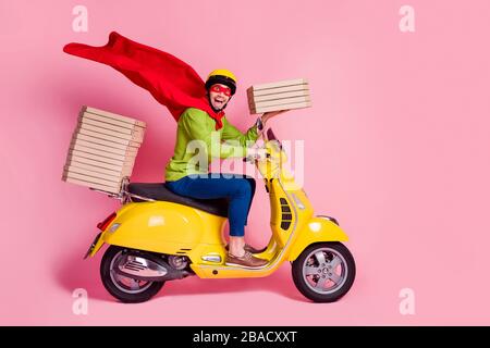 Profile side view of his he nice attractive funky cheerful cheery ecstatic guy driving moped fast speed wearing cape service order client hurry rush Stock Photo