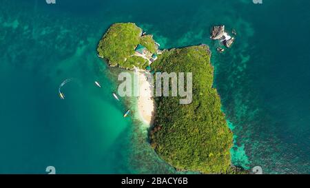 Travel concept: Sandy beach and turquoise water. Tourists on a tropical beach, aerial view. Marcos Island, Hundred Islands National Park, Pangasinan, Philippines. Alaminos. Summer and travel vacation concept Stock Photo