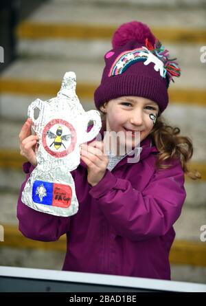 A young Brentford fan holds a hand made FA cup in the stands ahead of the match Stock Photo