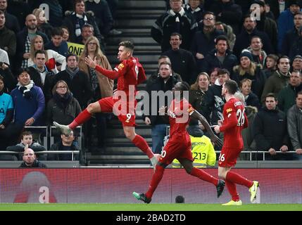 Liverpool's Roberto Firmino (left) celebrates scoring his side's first goal of the game with Sadio Mane and Andrew Robertson (right) Stock Photo