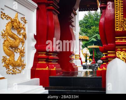Buddhist temple with white elephant red column with golden ornament in Chiang Rai, Thailand Stock Photo