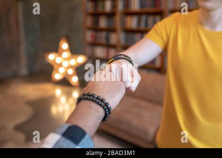 Close up picture of mans hands putting fist to fist Stock Photo
