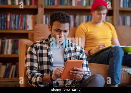 Handsome man in a checkered shirt surfing internet Stock Photo