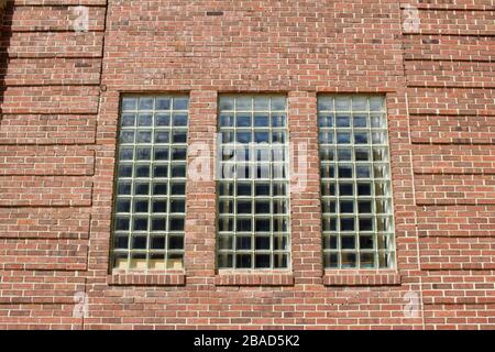 Close up view of a beautiful brown vintage brick wall texture background with large glass block windows Stock Photo