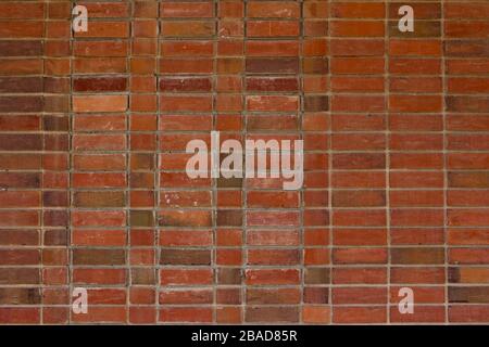 Older weathered red and brown brick wall texture background with a unique stack bond brickwork pattern. Stock Photo