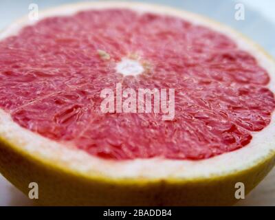 A sliced grapefruit on a plate Stock Photo