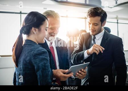 Group of Business People using tablet for Meeting Discussion Working Concept in meeting room Stock Photo