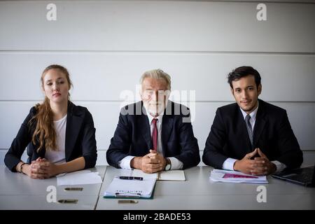 Businessmen and Businesswomen discussing documents for job interview concept Stock Photo