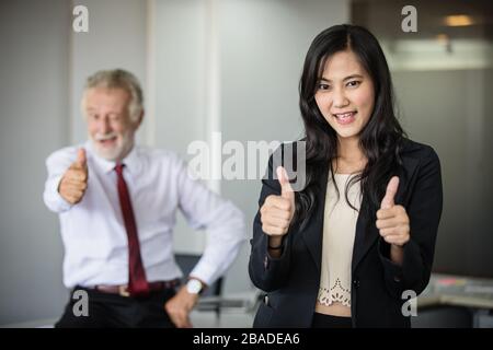 Asian business women and group using notebook for meeting and business women smiling happy for working Stock Photo