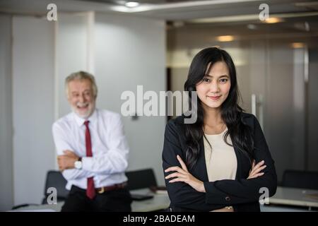 Asian business women and group using notebook for meeting and business women smiling happy for working Stock Photo