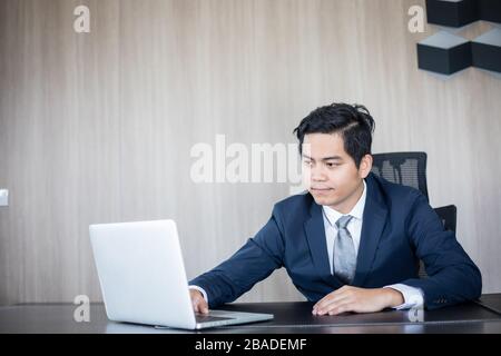 Asian business man and group using notebook for meeting and business men smiling happy for working Stock Photo
