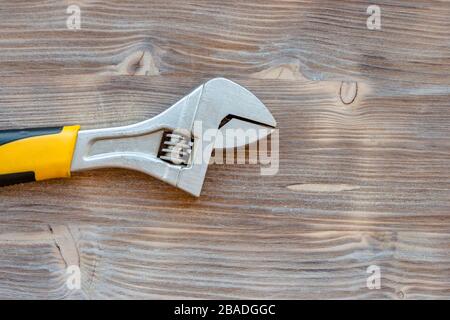 Labor fathers day concept. Repair tool spanner on whitewashed brown color wooden background. Stock Photo