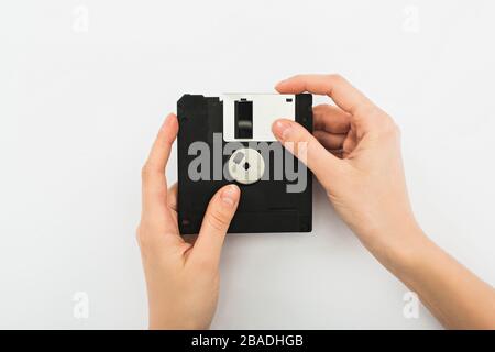 partial view of man holding diskette on white background Stock Photo