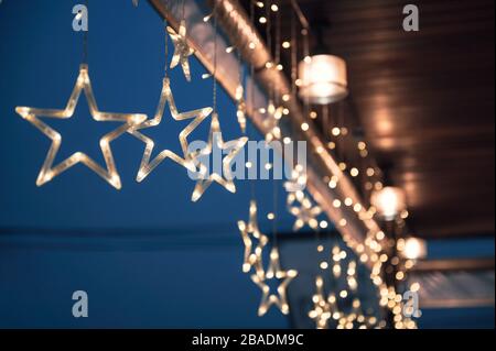 Star light bulb glowing and hanging on ceiling in Christmas festival Stock Photo