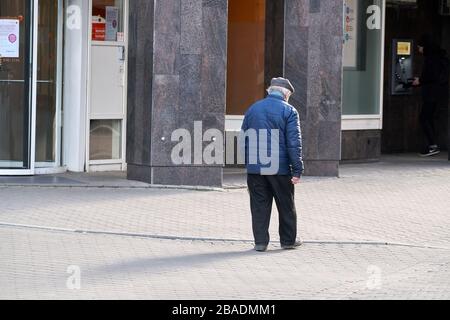 24-03-2020 - Riga, Latvia Unidentified old man walking in the city. Stock Photo