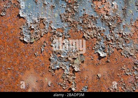 Rusty metal surface with flaking old dark paint Stock Photo