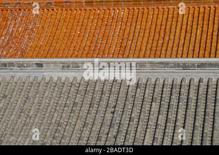 Abstract view of an image filling view of a red and grey roof of  two of the ancient palaces of the Forbidden City in Beijing China Stock Photo