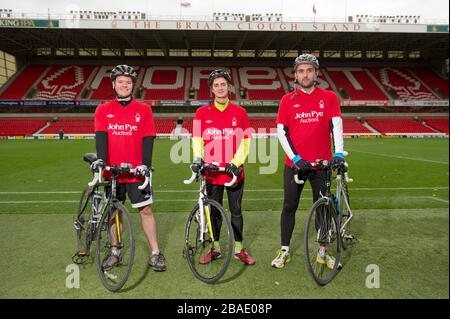 Cyclists Rowan Staszkiewicz, Scott Wilson and Matthew Vincent pitchside before their 26 mile bike ride from The City Ground, Nottingham to the King Power Stadium, Leicester to raise money for Prostate Cancer UK and the Alzheimer's Society. Stock Photo