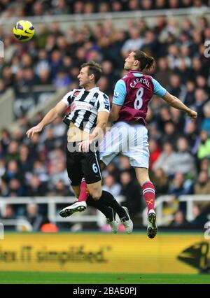 West Ham United's Andy Carroll (right) and Newcastle United's Mike Williamson (left) battle for the ball Stock Photo
