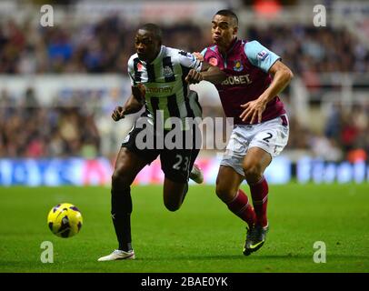 West Ham United's Winston Reid (right) and Newcastle United's Shola Ameobi (right) battle for the ball
