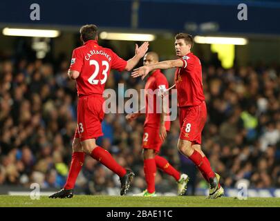 Liverpool's Jamie Carragher (left) celebrates with his team-mate Steven Gerrard (right) after assisting Luis Suarez (not in picture) in scoring their team's opening goal Stock Photo